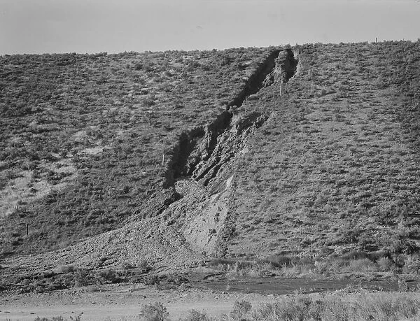 Water seepage from newly irrigated land on top of bench, eroding sides, Dead Ox Flat, Oregon, 1939. Creator: Dorothea Lange