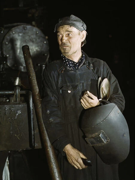 Welder at the C & NW RR locomotive shops, 40th Street shops, Chicago, Ill. 1942. Creator: Jack Delano