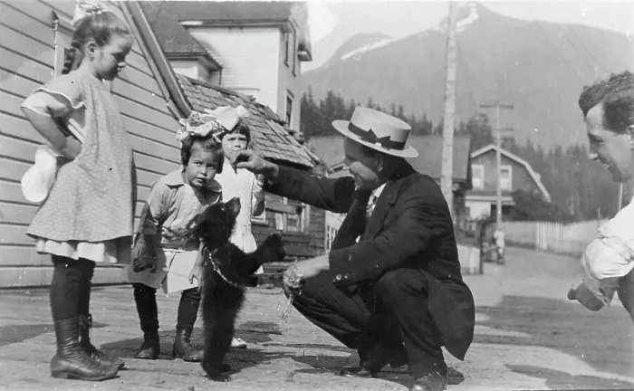 Framed Print : White people with bear cub, between c1900 and c1930. Creator: Unknown Framed Print : White people with bear cub, between c1900 and c1930. Creator: Unknown
