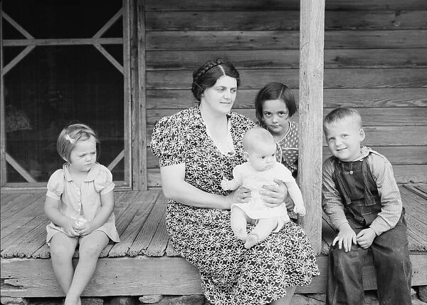 Wife and children of tobacco sharecropper on front porch, Person County, North Carolina, 1939. Creator: Dorothea Lange