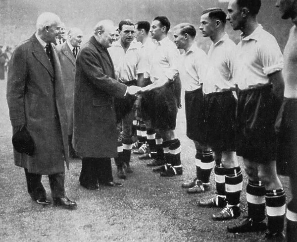 Winston Churchill greets the England football team, Wembley, London, October 1941. Artist: London News Agency
