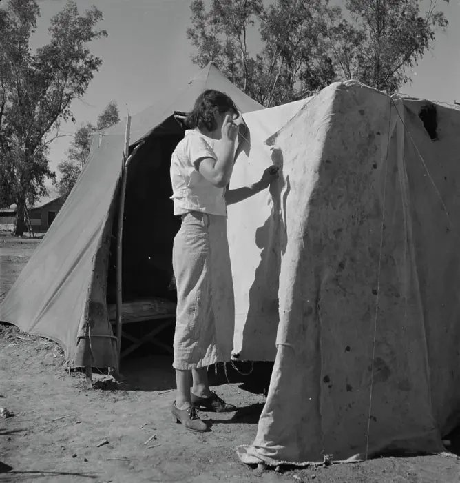Framed Print : Woman in a California pea pickers camp, mending the tent, 1937. Creator: Dorothea Lange Framed Print : Woman in a California pea pickers camp, mending the tent, 1937. Creator: Dorothea Lange