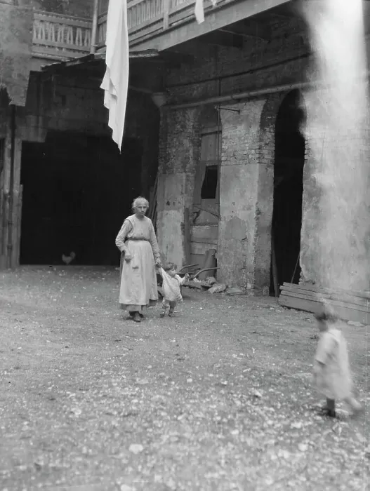 Framed Print : Woman and children in a courtyard, New Orleans, between 1920 and 1926. Creator: Arnold Genthe Framed Print : Woman and children in a courtyard, New Orleans, between 1920 and 1926. Creator: Arnold Genthe