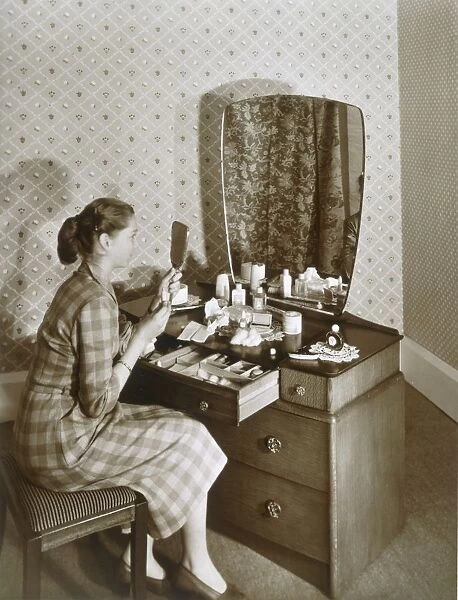Woman at her dressing table, c1955. Creator: English Photographer (20th Century)