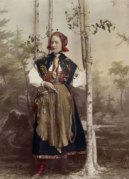 Woman in full figure dressed in costume from Floda parish, Dalarna, 1890-1920. Creator: Helene Edlund