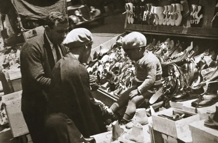 Framed Print : A woman from Harlem buys a pair of shoes for her child, New York, USA, c1920s-c1930s Framed Print : A woman from Harlem buys a pair of shoes for her child, New York, USA, c1920s-c1930s