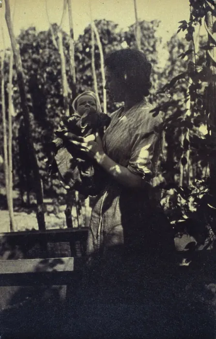 Framed Print : Woman holding an infant outdoors, between 1920 and 1940. Creator: Unknown Framed Print : Woman holding an infant outdoors, between 1920 and 1940. Creator: Unknown