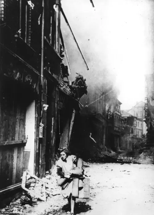 Framed Print : A woman leaving her burning house in a bombed street, Germany, 1945 Framed Print : A woman leaving her burning house in a bombed street, Germany, 1945