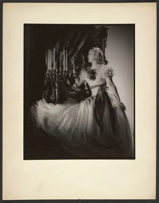 Framed Print : Woman lighting candelabra, 1930s. Creator: Gunther Krampf Framed Print : Woman lighting candelabra, 1930s. Creator: Gunther Krampf