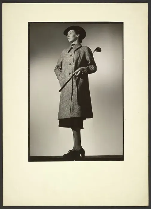 Framed Print : Woman modeling coat with golf club, early 1940s. Creator: Gunther Krampf Framed Print : Woman modeling coat with golf club, early 1940s. Creator: Gunther Krampf