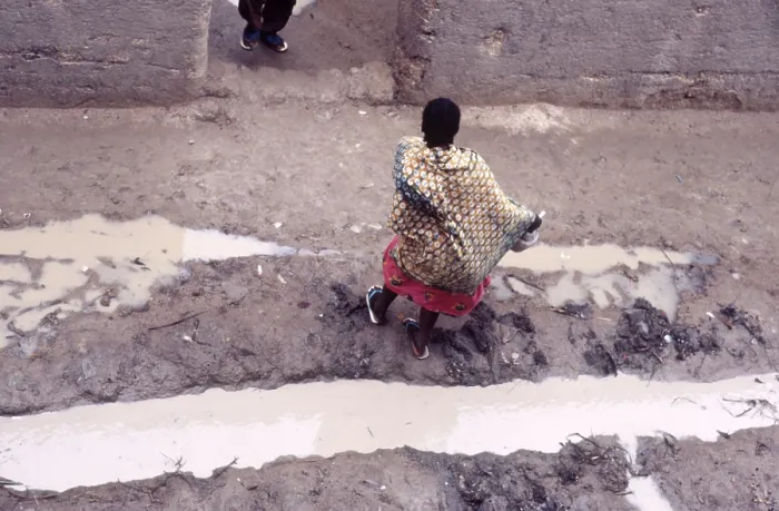 Framed Print : Woman in muddy street, Mopti, Mali, 1990. Creator: Amanda Waite Framed Print : Woman in muddy street, Mopti, Mali, 1990. Creator: Amanda Waite