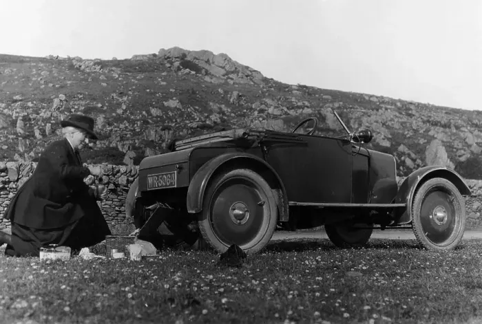 Framed Print : A woman picnicking next to her air-cooled Rover 8, c1919-c1925 Framed Print : A woman picnicking next to her air-cooled Rover 8, c1919-c1925