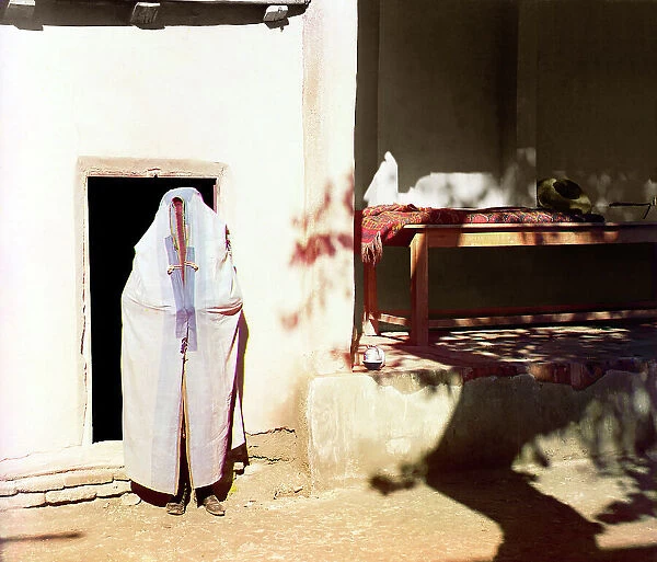 Woman in purdah, standing in front of doowrway, between 1905 and 1915. Creator: Sergey Mikhaylovich Prokudin-Gorsky