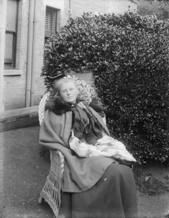 Framed Print : Woman sitting in a chair in a garden, c1900. Creator: Kirk & Sons of Cowes Framed Print : Woman sitting in a chair in a garden, c1900. Creator: Kirk & Sons of Cowes