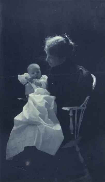 Framed Print : Woman, sitting in chair, holding an infant, full-length portrait, c1900. Creator: Sarah J. Eddy Framed Print : Woman, sitting in chair, holding an infant, full-length portrait, c1900. Creator: Sarah J. Eddy