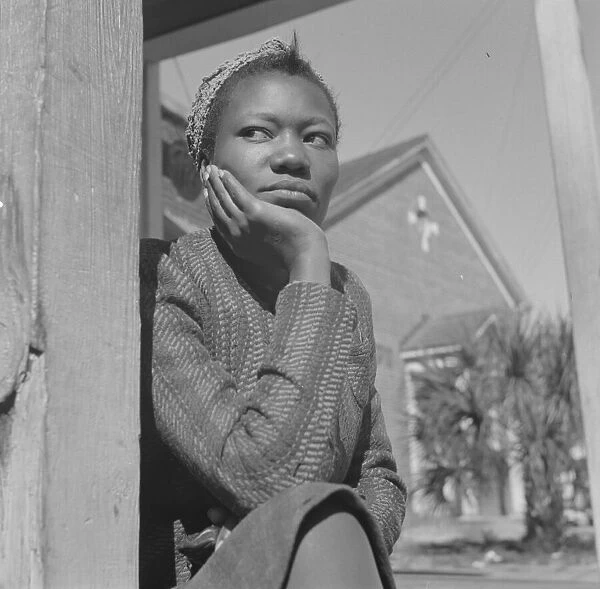 Woman sitting on her porch on Sunday morning, Daytona Beach, Florida, 1943. Creator: Gordon Parks