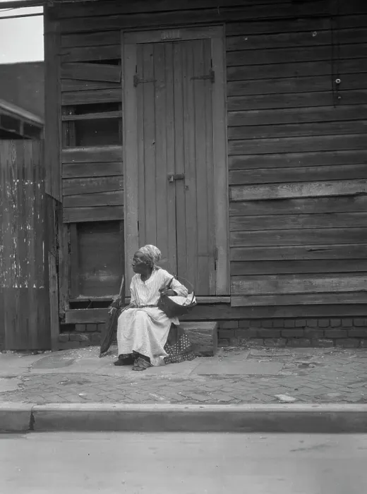 Framed Print : Woman sitting on steps holding a basket, New Orleans, between 1920 and 1926. Creator: Arnold Genthe Framed Print : Woman sitting on steps holding a basket, New Orleans, between 1920 and 1926. Creator: Arnold Genthe