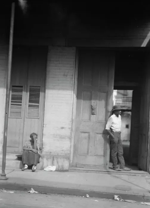 Framed Print : Woman sitting on steps and man standing in a doorway, New Orleans, between 1920 and 1926. Creator: Arnold Genthe Framed Print : Woman sitting on steps and man standing in a doorway, New Orleans, between 1920 and 1926. Creator: Arnold Genthe