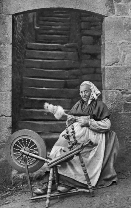 Framed Print : A woman at a spinning wheel, Dinan, Brittany, France, c1922 Framed Print : A woman at a spinning wheel, Dinan, Brittany, France, c1922