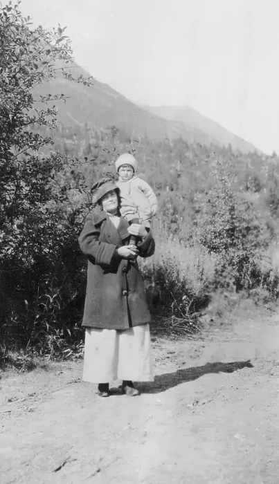 Framed Print : Woman standing on dirt road holding child; mountains in background, between c1900 and 1916. Creator: Unknown Framed Print : Woman standing on dirt road holding child; mountains in background, between c1900 and 1916. Creator: Unknown