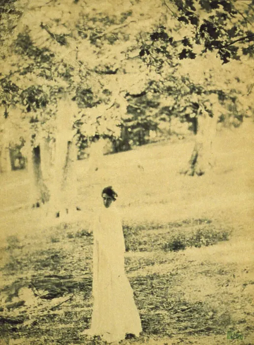 Framed Print : Woman standing in a park, trees in background, c1900. Creator: Eva Watson-Schutze