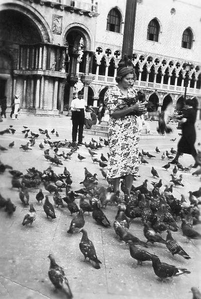 Woman surrounded by pigeons, St Marks Square, Venice, Italy, 1938