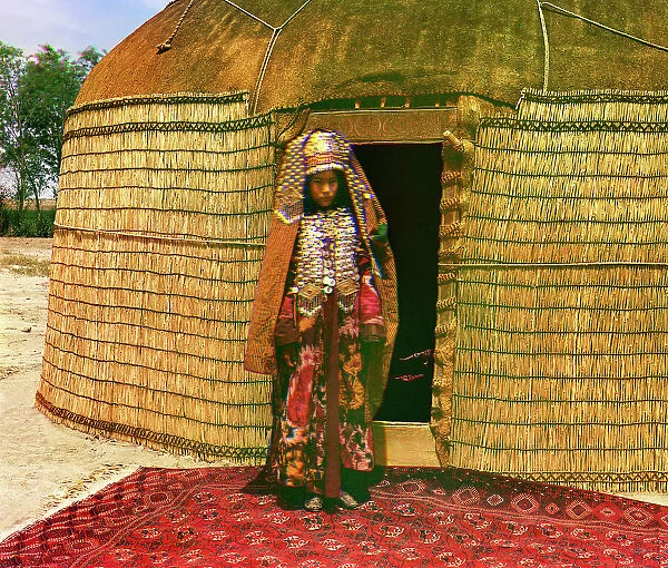 Woman in traditional dress and jewelry standing on rug in front of yurt, between 1905 and 1915. Creator: Sergey Mikhaylovich Prokudin-Gorsky