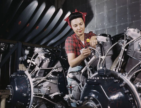 Woman working on an airplane motor at North American Aviation, Inc. plant in Calif. 1942. Creator: Alfred T Palmer