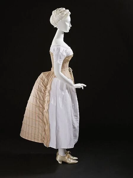 Woman's bustle, England, c.1885. Corset: c.1865-75, Chemise: c.1850-70, Shoes: 1875-1900. Creator: Unknown