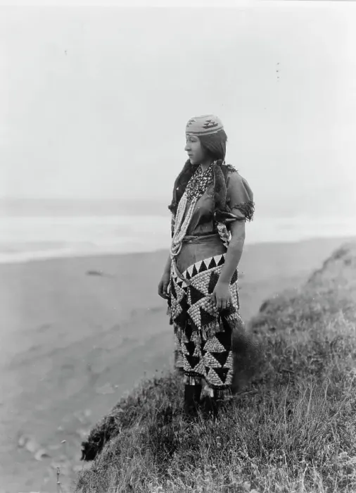 Framed Print : Woman's primitive dress-Tolowa, c1923. Creator: Edward Sheriff Curtis Framed Print : Woman's primitive dress-Tolowa, c1923. Creator: Edward Sheriff Curtis
