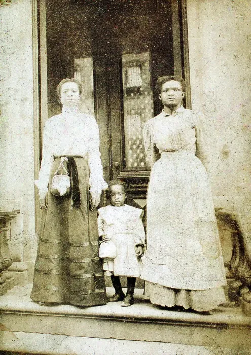 Framed Print : Two women and a child standing on step in front of a doorway of a house, c1900. Creator: Eckehard Munck Framed Print : Two women and a child standing on step in front of a doorway of a house, c1900. Creator: Eckehard Munck