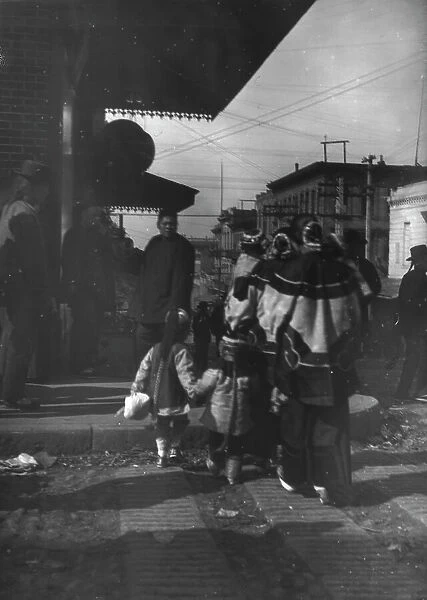 Women and children crossing a street, Chinatown, San Francisco, between 1896 and 1906. Creator: Arnold Genthe