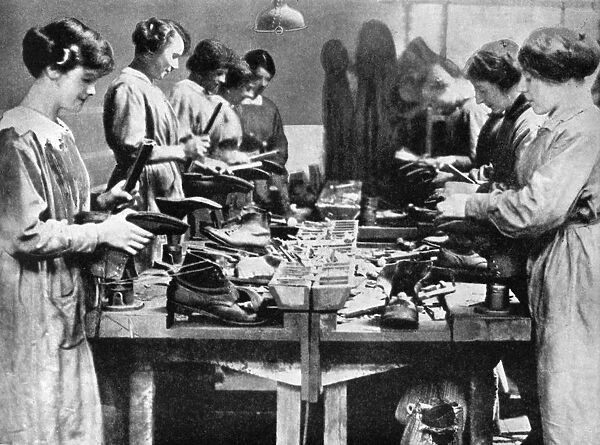 Women cobblers repairing footwear for the war effort, 1914-1918 (1936)