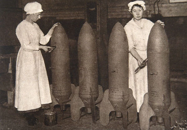 Women munitions workers putting a coat of paint on aerial bombs, World War I, c1914-c1918