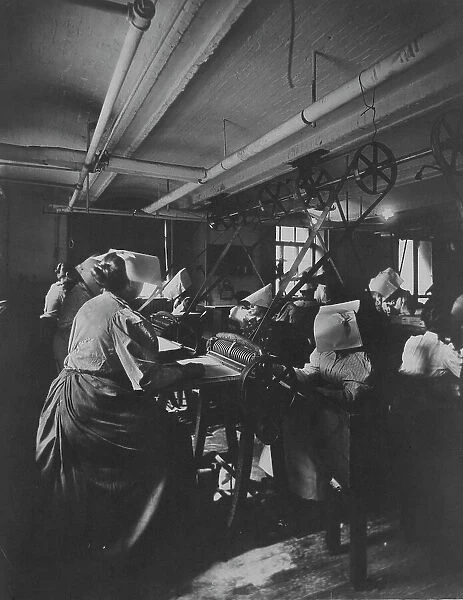 Women perforating sheets of stamps in the Stamp Division at the Bureau of Engraving... c1895. Creator: Frances Benjamin Johnston