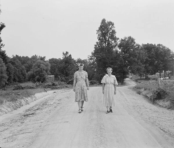 Women walking down the road to see a sick neighbor, Person County, North Carolina, 1939. Creator: Dorothea Lange