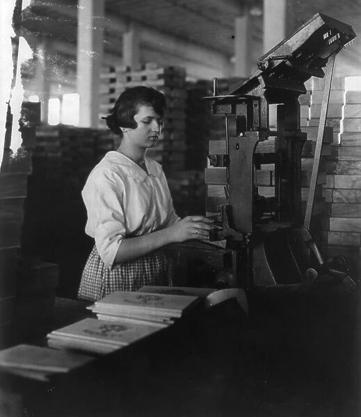 Wooden Box Industry: young woman working at machine, c1910. Creator: Frances Benjamin Johnston