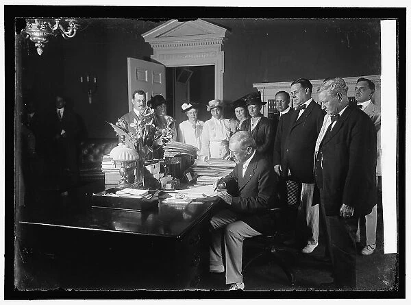 Woodrow Wilson signing Child Labor Bill, 1916. Creator: Harris & Ewing. Woodrow Wilson signing Child Labor Bill, 1916. Creator: Harris & Ewing