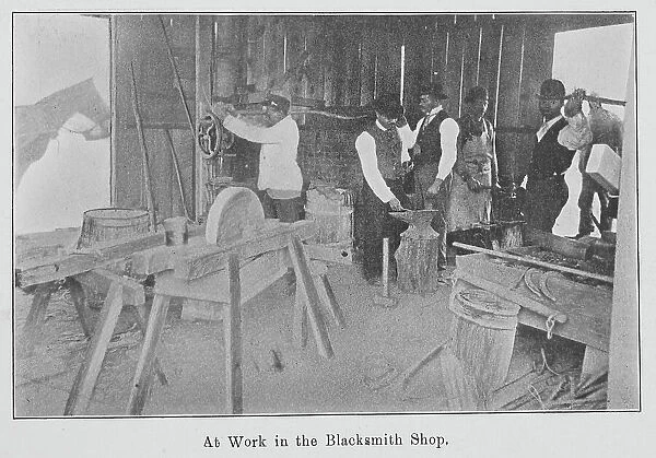 At work in the Blacksmith Shop. 1903. Creator: Unknown