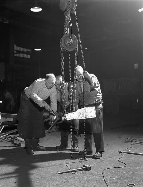 Three workers from Edgar Allens handle a red hot billet, Sheffield, South Yorkshire, 1963