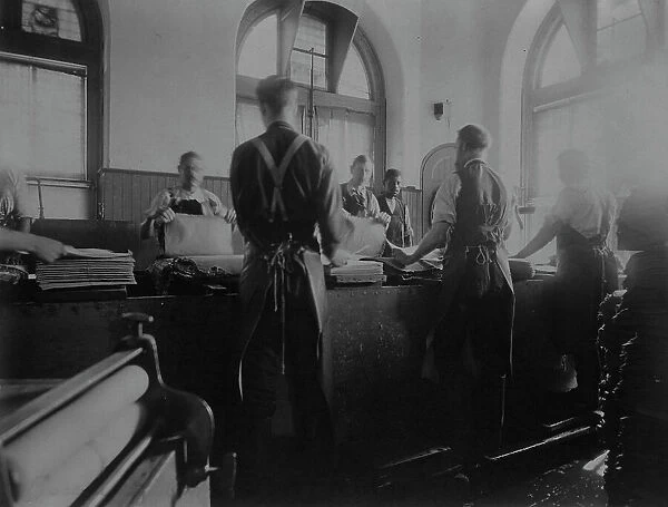Workers wetting sheets prior to printing paper money at the Bureau of Engraving & Printing, c1895. Creator: Frances Benjamin Johnston. Workers wetting sheets prior to printing paper money at the Bureau of Engraving & Printing, c1895
