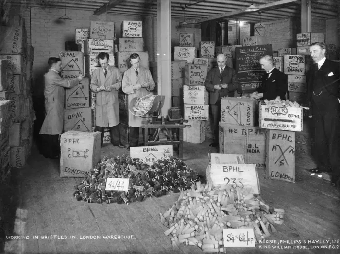 Framed Print : Working with bristles in a warehouse, London, 1938 Framed Print : Working with bristles in a warehouse, London, 1938
