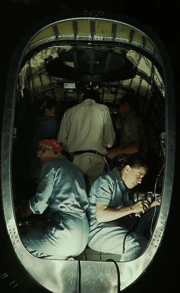 Working inside fuselage of a Liberator Bomber, Consolidated Aircraft Corp. Fort Worth, Texas, 1942. Creator: Howard Hollem