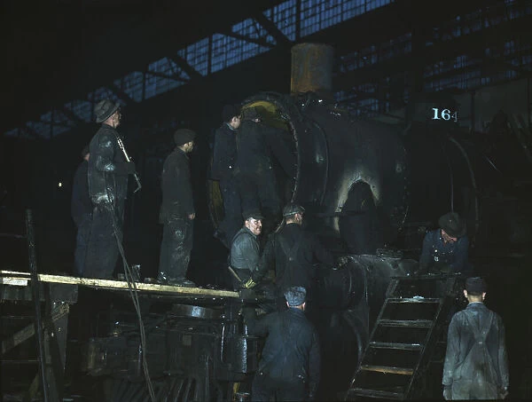 Working on a locomotive at the 40th Street shop of the C & NW RR, Chicago, Ill. 1942. Creator: Jack Delano