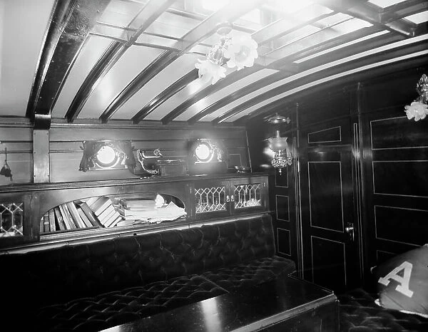 Yacht Althea, cabin, showing books, between 1907 and 1915. Creator: Unknown