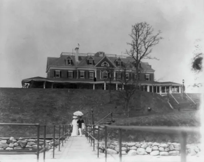 Framed Print : Yacht club, Oyster Bay, Long Island, N.Y. Couple walking on far end of bridge or pier, 1905. Creator: Frances Benjamin Johnston