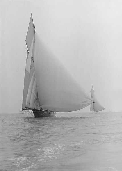 The yawl Wendur sailing with spinnaker, 1913. Creator: Kirk & Sons of Cowes