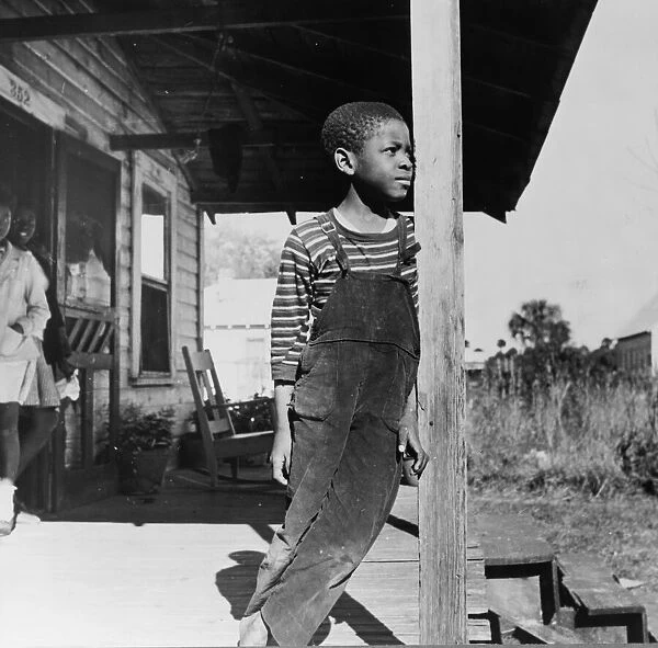 Young boy on his front porch, Daytona Beach, Florida, 1943. Creator: Gordon Parks