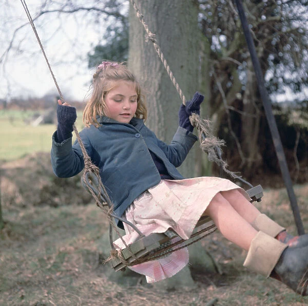 Young gipsy girl on a swing, Charlwood, Newdigate area, Surrey, 1964