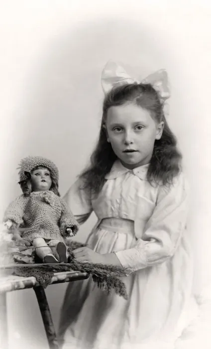 Framed Print : A young girl holding a doll, 20th century Framed Print : A young girl holding a doll, 20th century